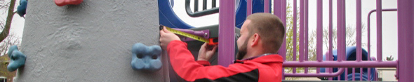 Inspector measuring a playground